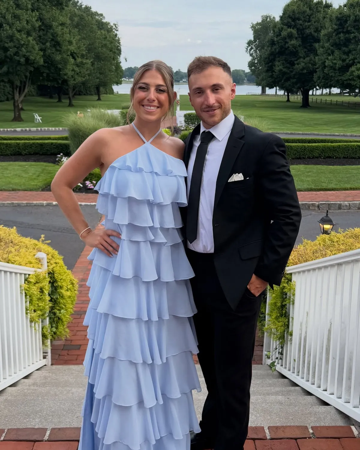 Sean Calhoun and his wife, Gianna, dressed up outdoors on a summer evening